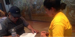 Rosa, a Local 400 organizer, helps a green card holder apply for citizenship.