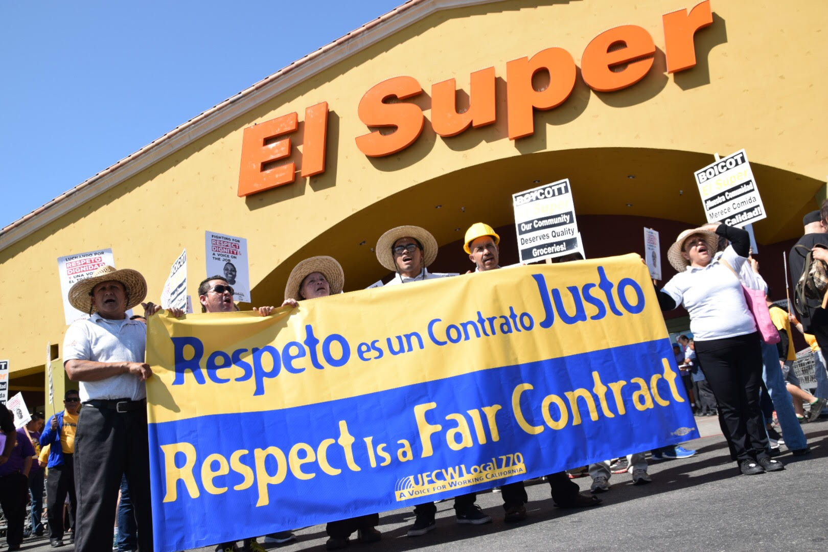 UFCW members hold a "Respect is a Fair Contract" sign outside of El Super