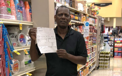 UFCW Local 400 member Eric Jarett holds up a check