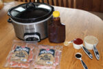 Cocktail Smokies and other ingredients next to a crockpot