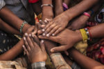 Children's hands together in a circle