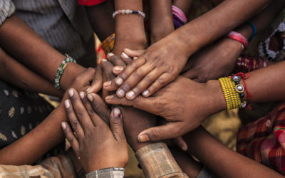 Children's hands together in a circle