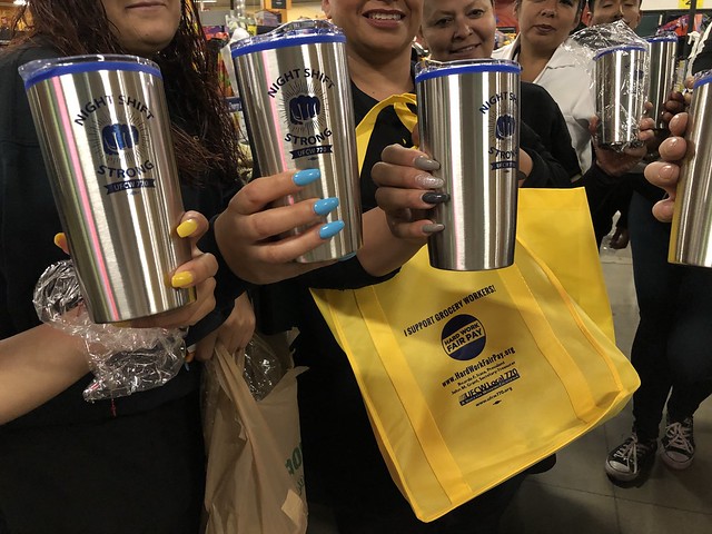 UFCW Local 770 members hold up their "Night Shift Strong" mugs from Third Shift Day