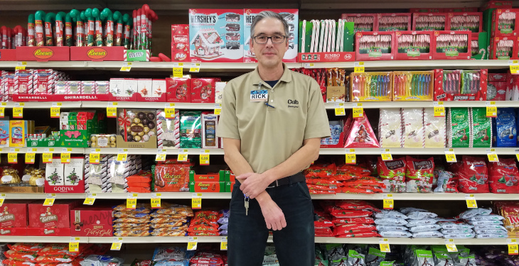Rick Phelps stands in front of grocery store shelves
