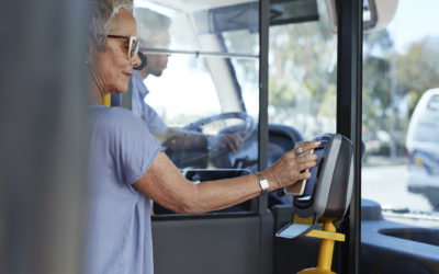 Woman uses her phone to pay her bus fare