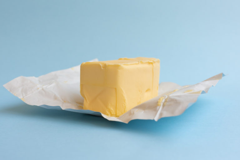 Close-Up Of Butter On Blue Background