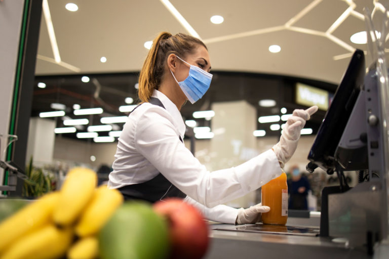 Grocery Cashier Wearing Mask While Working